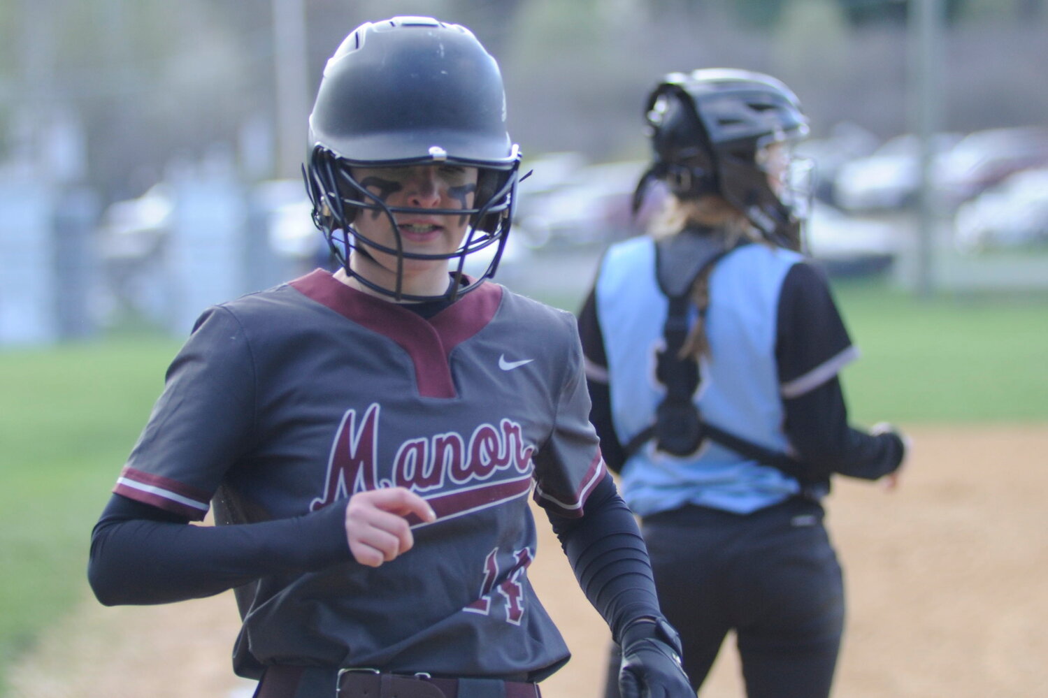 Score one for the visitors. Manor’s Jillian Carlsen adds a run to the Lady Wildcats’ 8-6 victory.